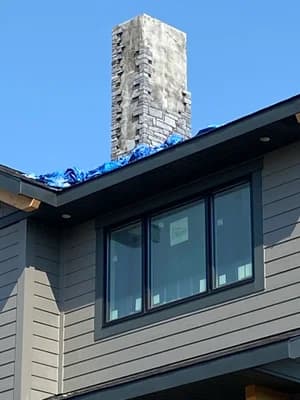 Rooftop stone chimney construction