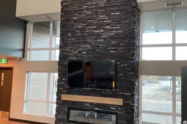 Modern stacked slate fireplace with TV mount